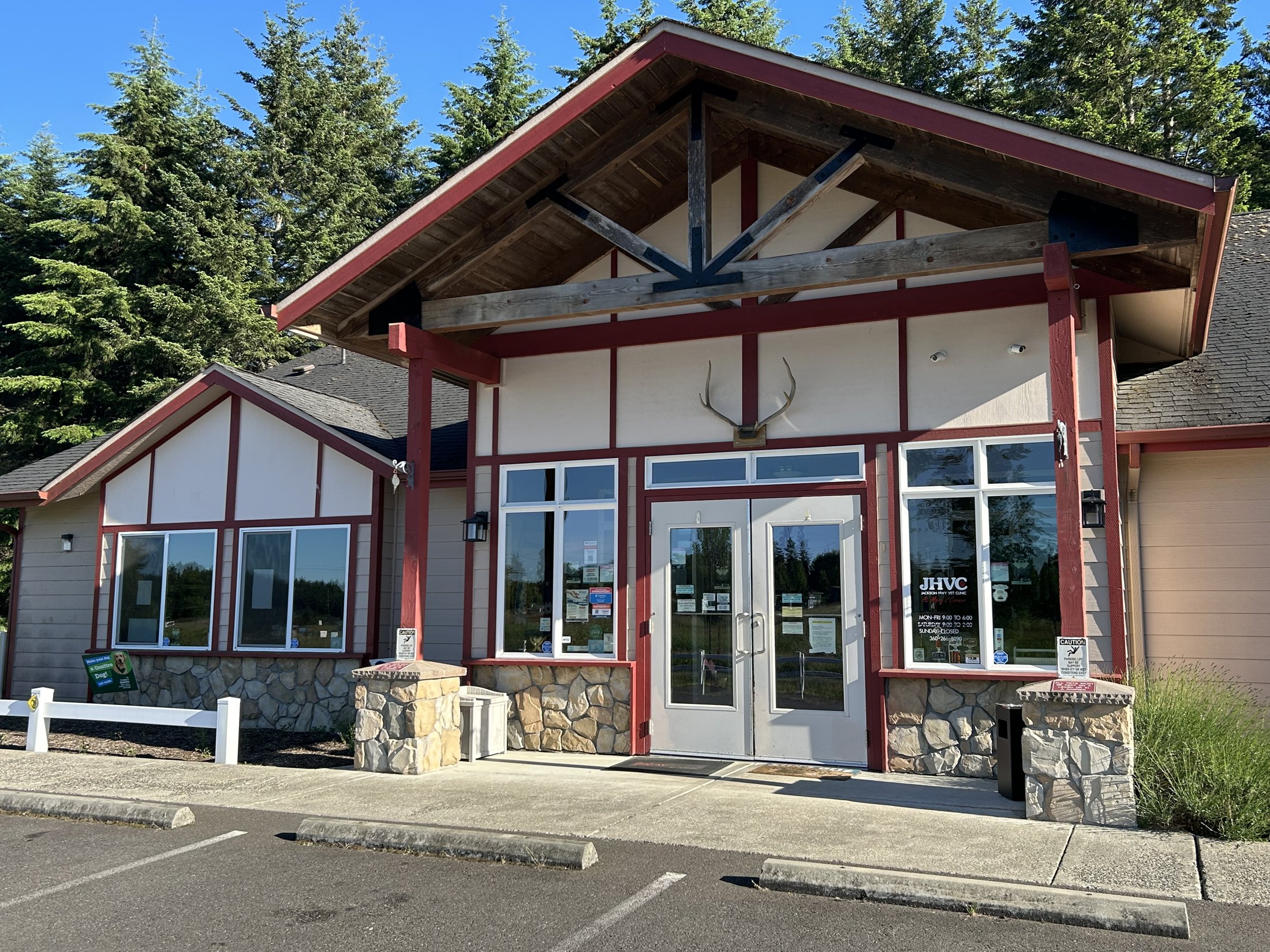 The front entrance of the clinic with its timber porch and stone pillars