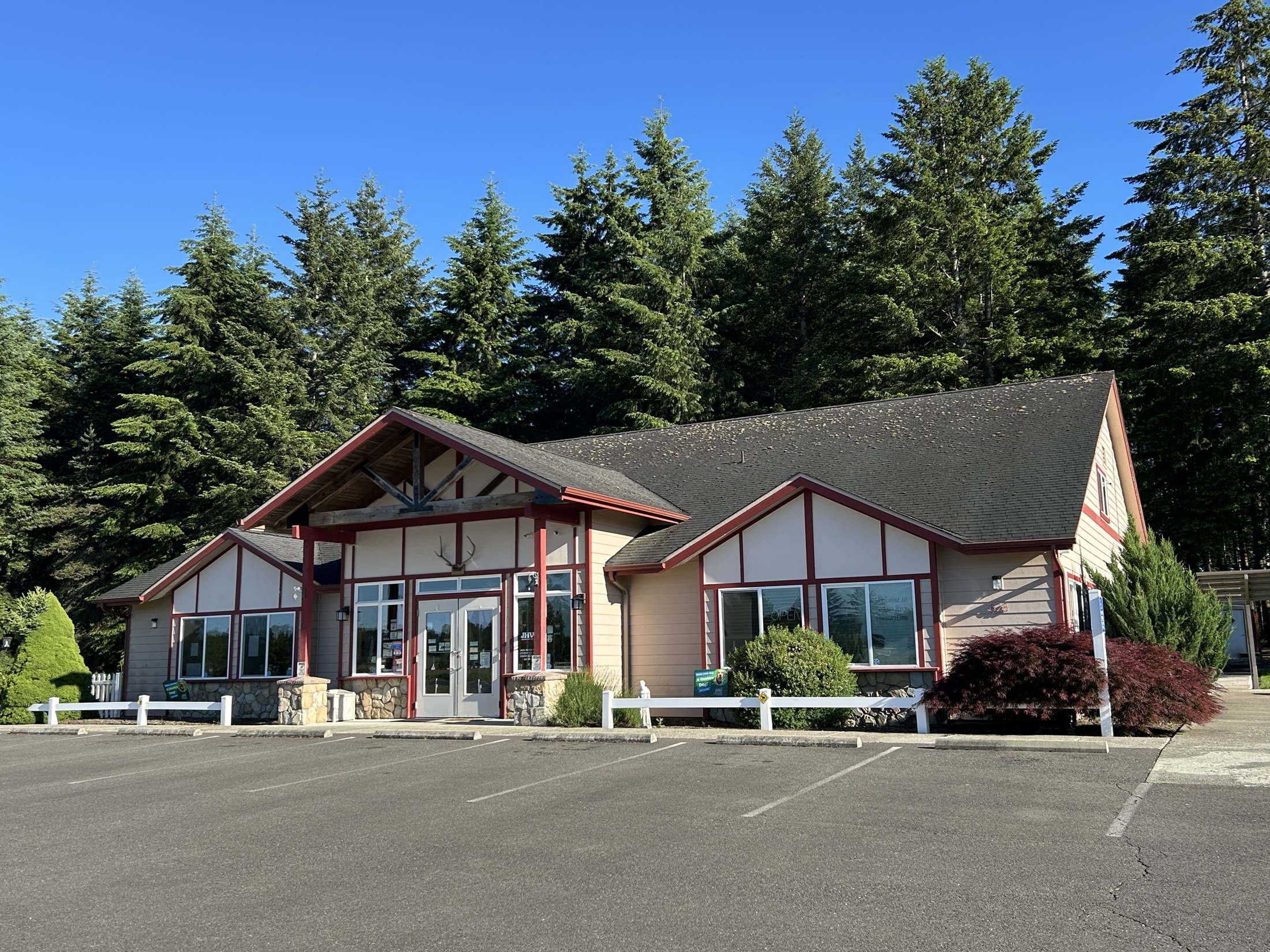 The clinic, a timber building among the fir trees on Highway 12